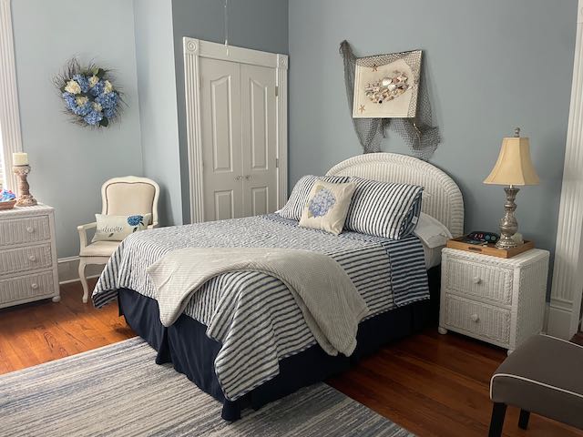 Room view with seashell decor and queen bed